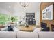 Bright living room featuring a brick fireplace, built-in shelving, and large windows for plenty of natural light at 109 Lochview Dr, Cary, NC 27518