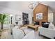 Bright living room featuring a brick fireplace, built-in shelving, and an open layout with natural light at 109 Lochview Dr, Cary, NC 27518