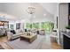 Bright living room with vaulted ceilings, large windows offering nature views, and neutral furniture throughout at 109 Lochview Dr, Cary, NC 27518