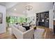 Bright living room showcases a brick fireplace, built-in shelving, and large windows for natural light at 109 Lochview Dr, Cary, NC 27518