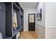 Mudroom with storage shelves and a coat rack next to a door with a window at 109 Lochview Dr, Cary, NC 27518