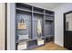 Built-in mudroom shelving with coat hooks and lower baskets for storage; conveniently organized and beautifully designed at 109 Lochview Dr, Cary, NC 27518