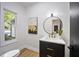 Stylish powder room featuring a modern vanity with marble countertop and gold fixtures at 109 Lochview Dr, Cary, NC 27518