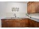 Stylish wet bar with wooden cabinets, granite countertop, and modern fixtures at 109 Lochview Dr, Cary, NC 27518