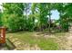 A spacious backyard features mature trees, offering privacy and natural beauty to the property at 1095 Vauxhall Dr, Apex, NC 27502