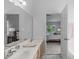 Bathroom featuring double sinks in vanity, with attached bedroom through doorway at 1095 Vauxhall Dr, Apex, NC 27502