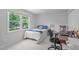 Bright bedroom with large window, cozy bed, a desk and rolling chair setup at 1095 Vauxhall Dr, Apex, NC 27502