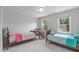 Bright bedroom with two twin beds and two windows providing natural light at 1095 Vauxhall Dr, Apex, NC 27502