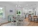 Bright dining area featuring hardwood floors, a modern light fixture and a sliding glass door to the backyard at 1095 Vauxhall Dr, Apex, NC 27502