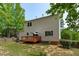 A two-story house features vinyl siding, a deck, and a backyard with partial grass coverage at 1095 Vauxhall Dr, Apex, NC 27502