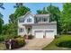 Charming two-story home boasts a landscaped front yard and a convenient two-car garage at 1095 Vauxhall Dr, Apex, NC 27502