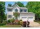 Charming two-story home boasts a landscaped front yard and a convenient two-car garage at 1095 Vauxhall Dr, Apex, NC 27502