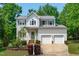 Charming two-story home boasts a landscaped front yard and a convenient two-car garage at 1095 Vauxhall Dr, Apex, NC 27502