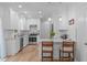 Stylish white kitchen with stainless steel appliances, subway tile backsplash, and eat-in breakfast bar at 1095 Vauxhall Dr, Apex, NC 27502