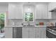 Well-lit kitchen features stainless steel appliances, white cabinetry, and a window above the sink at 1095 Vauxhall Dr, Apex, NC 27502