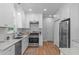 Bright kitchen featuring stainless steel appliances, white cabinetry, and granite countertops at 1095 Vauxhall Dr, Apex, NC 27502