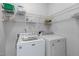 Laundry room with modern appliances and ample shelving for storage at 1095 Vauxhall Dr, Apex, NC 27502
