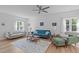 Bright living room with hardwood floors, neutral walls, and a cozy seating area at 1095 Vauxhall Dr, Apex, NC 27502