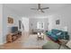 Bright living room with hardwood floors, neutral walls, and a cozy seating area at 1095 Vauxhall Dr, Apex, NC 27502