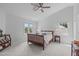 This main bedroom is light and airy with a ceiling fan and dual windows at 1095 Vauxhall Dr, Apex, NC 27502