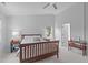 Light and airy main bedroom features a ceiling fan, dual windows and ensuite access at 1095 Vauxhall Dr, Apex, NC 27502