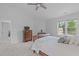 Spacious main bedroom featuring plush carpets, a large window, and ensuite access at 1095 Vauxhall Dr, Apex, NC 27502