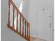 Stairwell with wood railing and a white door at 1095 Vauxhall Dr, Apex, NC 27502