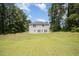 Exterior of home with large backyard with mature trees and open lawn at 11 Mamie Ferguson Dr, Lillington, NC 27546