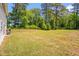 Expansive backyard featuring a large grassy area with lush surrounding trees at 11 Mamie Ferguson Dr, Lillington, NC 27546