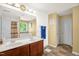 Bathroom with a double sink vanity, a large mirror with modern lighting, and a door to the toilet and shower at 11 Mamie Ferguson Dr, Lillington, NC 27546