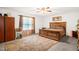 Bedroom with a wooden bed frame, ceiling fan, area rug, window, and an assortment of bedroom furniture at 11 Mamie Ferguson Dr, Lillington, NC 27546