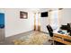 Well lit bedroom featuring a workstation, neutral walls and carpet, and a beige and green decorative area rug at 11 Mamie Ferguson Dr, Lillington, NC 27546