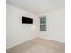 Neutral bedroom featuring carpet, a wall mounted television, and natural light at 11 Mamie Ferguson Dr, Lillington, NC 27546
