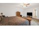 Bedroom with neutral walls, area rug, a wooden bed frame and furniture, and a TV atop a console at 11 Mamie Ferguson Dr, Lillington, NC 27546