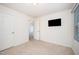 Cozy bedroom with neutral carpet, a wall mounted television, and entry to the hall at 11 Mamie Ferguson Dr, Lillington, NC 27546