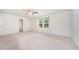 An empty bedroom featuring carpet floors, a ceiling fan and a window for natural light at 11 Mamie Ferguson Dr, Lillington, NC 27546
