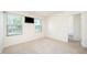 Sunlit bedroom featuring neutral walls, carpet, and two windows with natural light at 11 Mamie Ferguson Dr, Lillington, NC 27546