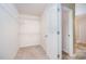 Walk in closet that features carpet floors and metal racks for storage at 11 Mamie Ferguson Dr, Lillington, NC 27546