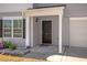 Close-up of the front entrance featuring a black door with decorative plants nearby at 11 Mamie Ferguson Dr, Lillington, NC 27546