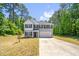 Charming two-story home with a concrete driveway and an attached two-car garage at 11 Mamie Ferguson Dr, Lillington, NC 27546