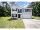 Charming two-story home with a manicured lawn and a two-car garage at 11 Mamie Ferguson Dr, Lillington, NC 27546