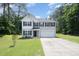 Charming two-story home with a manicured lawn and a two-car garage at 11 Mamie Ferguson Dr, Lillington, NC 27546