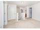 Upstairs hallway with white trim, neutral walls, and multiple doorways leading to other rooms at 11 Mamie Ferguson Dr, Lillington, NC 27546