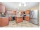 Traditional kitchen features wood cabinetry, center island and tile backsplash at 11 Mamie Ferguson Dr, Lillington, NC 27546