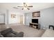 Bright living room with TV, neutral walls and carpet, and doorway to kitchen at 11 Mamie Ferguson Dr, Lillington, NC 27546