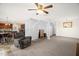 Open living area featuring a comfortable recliner, stairs, and access to kitchen at 11 Mamie Ferguson Dr, Lillington, NC 27546