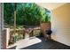 Charming back porch has a grill, wooden fence, brick accent wall, and green surroundings at 111 Florians Dr, Holly Springs, NC 27540