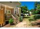 Cozy backyard deck with wooden steps and lush green lawn and beautiful garden scenery at 111 Florians Dr, Holly Springs, NC 27540