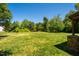 The backyard features a vast lawn and stone corner posts at 111 Florians Dr, Holly Springs, NC 27540