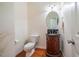 Powder room featuring a wood vanity with a dark countertop at 111 Florians Dr, Holly Springs, NC 27540